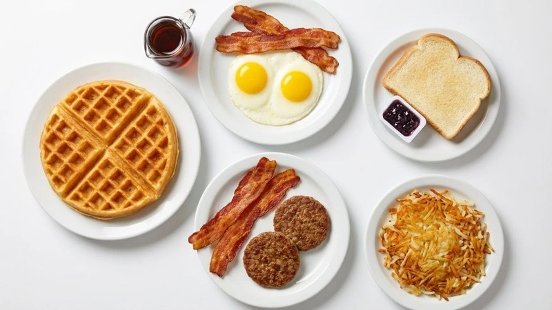 Overhead photo of the Waffle House All-Star Special with waffle, eggs, bacon, sausage, toast, and hashbrowns.